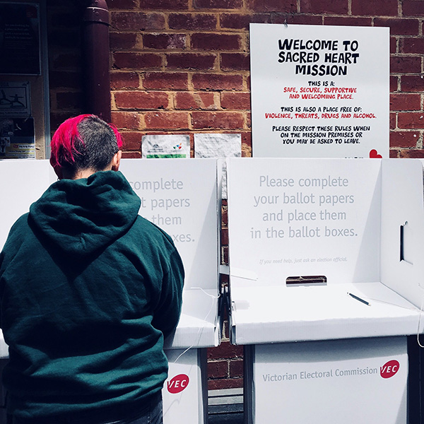 A voter casts their vote at Sacred Heart Mission homelessness service in Melbourne.