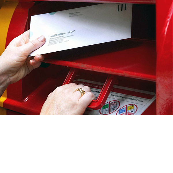 Person posting a letter into an Australia Post postbox