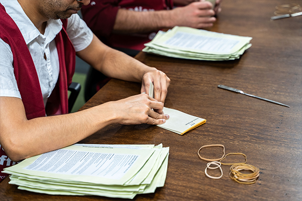 Staff counting votes at a state election centre.