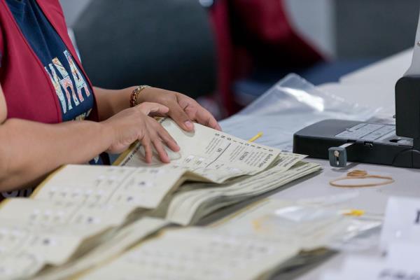 Close up photo of election official counting upper house ballot papers